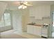 Small kitchenette with white cabinets and a window at 3592 Galdway Dr, Snellville, GA 30039