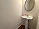 A half bathroom features tile flooring and a pedestal sink at 5872 Oakbrook Lake Ct, Norcross, GA 30093