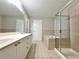 Bathroom features a soaking tub, glass shower, dual vanities, and tile flooring at 5872 Oakbrook Lake Ct, Norcross, GA 30093