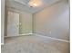 Spacious bedroom features neutral carpeting, ample natural light, and a door at 5872 Oakbrook Lake Ct, Norcross, GA 30093