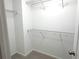 Walk-in closet with metal shelving and neutral carpeting at 5872 Oakbrook Lake Ct, Norcross, GA 30093