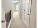 A bright hallway connects the bedrooms with carpeted floors at 5872 Oakbrook Lake Ct, Norcross, GA 30093