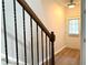 Bright hallway with hardwood floors and black iron railing at 5872 Oakbrook Lake Ct, Norcross, GA 30093
