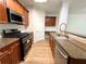 Kitchen with stainless steel appliances, wood cabinets, and granite countertops at 5872 Oakbrook Lake Ct, Norcross, GA 30093