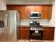 This kitchen features stainless steel appliances and wooden cabinets at 5872 Oakbrook Lake Ct, Norcross, GA 30093