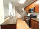 Well-lit kitchen with stainless steel appliances, wooden cabinets, and granite countertops at 5872 Oakbrook Lake Ct, Norcross, GA 30093
