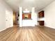 Open-concept living room with access to the kitchen, wood floors, and lots of light at 5872 Oakbrook Lake Ct, Norcross, GA 30093