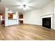 Open-concept living room with fireplace and wood floors, adjacent to the kitchen at 5872 Oakbrook Lake Ct, Norcross, GA 30093