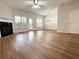 Open-concept living room with wood floors, a fireplace, and access to the patio at 5872 Oakbrook Lake Ct, Norcross, GA 30093