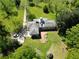 Overhead view of a home with mature trees, a garden area, and circular driveway at 11433 Panhandle Rd, Hampton, GA 30228