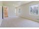 Bedroom with light colored walls and carpeted flooring with outside view at 11433 Panhandle Rd, Hampton, GA 30228