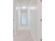 Hallway with neutral carpet, fresh paint, crown molding, and abundant natural light at 11433 Panhandle Rd, Hampton, GA 30228