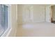 Bright living room with white walls and carpet, and features a window with natural light at 11433 Panhandle Rd, Hampton, GA 30228