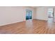 Bright living room with wood-look flooring and sliding glass doors leading to sunroom at 11433 Panhandle Rd, Hampton, GA 30228