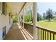 Covered porch with classic columns, decorative lighting, and a serene outdoor view at 11433 Panhandle Rd, Hampton, GA 30228