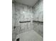 Clean shower with white tile walls, patterned floor tile, and safety bars at 11433 Panhandle Rd, Hampton, GA 30228