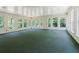 Spacious sunroom featuring multiple windows and a green carpet at 11433 Panhandle Rd, Hampton, GA 30228
