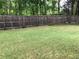 Fenced backyard featuring a well-maintained lawn and a wooden fence, offering privacy at 431 Crested View Dr, Loganville, GA 30052