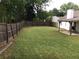 Spacious fenced backyard with lawn, and a covered patio with chairs for outdoor enjoyment at 431 Crested View Dr, Loganville, GA 30052