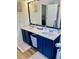 Bathroom featuring a dual sink vanity, a large mirror, and luxury vinyl plank flooring at 431 Crested View Dr, Loganville, GA 30052