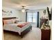 Cozy bedroom features a ceiling fan, nice furnishings, neutral carpet, and a bright window view at 431 Crested View Dr, Loganville, GA 30052