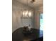 Stylish dining room features a unique chandelier and a view of the backyard at 431 Crested View Dr, Loganville, GA 30052