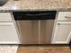 Close-up view of a stainless steel Frigidaire dishwasher under a granite countertop in the kitchen at 431 Crested View Dr, Loganville, GA 30052