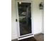 White front door with a glass insert, sidelight, and decorative lantern, offering a welcoming entrance at 431 Crested View Dr, Loganville, GA 30052
