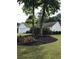 Landscaped front yard featuring flowers, trees, and well-maintained bushes at 431 Crested View Dr, Loganville, GA 30052