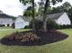 Landscaped front yard with colorful flowers and mature trees at 431 Crested View Dr, Loganville, GA 30052