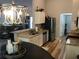 Bright kitchen with granite countertops, modern appliances, a stylish pendant light, and adjacent living area at 431 Crested View Dr, Loganville, GA 30052