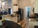 Well-lit kitchen features granite countertops, stainless steel appliances, and wood floors at 431 Crested View Dr, Loganville, GA 30052