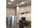 Modern kitchen with white cabinets, granite countertops, stainless steel appliances, and vaulted ceilings at 431 Crested View Dr, Loganville, GA 30052