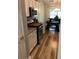 Modern kitchen with stainless steel appliances, granite countertops, and hardwood flooring, adjacent to dining area at 431 Crested View Dr, Loganville, GA 30052