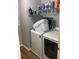 Laundry area features new washer and dryer, plus storage shelves at 431 Crested View Dr, Loganville, GA 30052