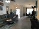 Open-concept living area with a comfortable sectional sofa and barstool seating at 431 Crested View Dr, Loganville, GA 30052