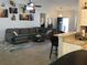 Open concept living space with a large sectional couch, kitchen bar, and bright natural light at 431 Crested View Dr, Loganville, GA 30052