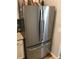 Stainless steel refrigerator with French doors and granite countertops in a modern kitchen setting at 431 Crested View Dr, Loganville, GA 30052