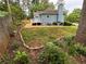 Backyard features a deck, trees, lush green grass, and manicured garden beds at 504 Radford Ct, Woodstock, GA 30188