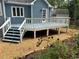 Exterior image of a blue painted wood home with a deck, stairs and landscaped yard with roses at 504 Radford Ct, Woodstock, GA 30188
