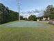 Exterior image of a basketball court on a grassy lawn with a bench and houses in the background at 504 Radford Ct, Woodstock, GA 30188