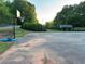 Exterior view of cracked asphalt basketball court with portable basketball hoop at 504 Radford Ct, Woodstock, GA 30188
