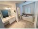 Bright bathroom featuring a soaking tub, tiled floors, and white vanity at 504 Radford Ct, Woodstock, GA 30188