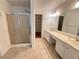 Bright bathroom features a double sink vanity, large mirror, and a glass-enclosed shower at 504 Radford Ct, Woodstock, GA 30188