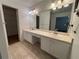 Bathroom featuring dual sinks, vanity, and a large mirror at 504 Radford Ct, Woodstock, GA 30188