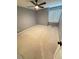 Neutral bedroom features a ceiling fan and a window letting in plenty of natural light at 504 Radford Ct, Woodstock, GA 30188
