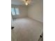 Spacious bedroom features neutral carpets and a window letting in plenty of natural light at 504 Radford Ct, Woodstock, GA 30188