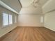 Spacious bedroom features a vaulted ceiling, ceiling fan, and natural light from large windows at 504 Radford Ct, Woodstock, GA 30188