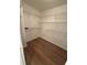 Walk-in closet with hardwood floors and wire shelving for storage at 504 Radford Ct, Woodstock, GA 30188