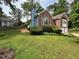 A beautiful brick home with blue siding, lush green lawn, and mature trees at 504 Radford Ct, Woodstock, GA 30188